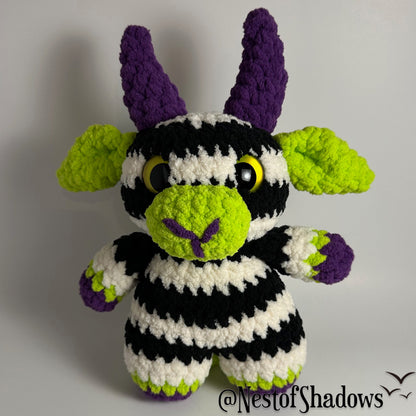 Crochet goat with stripes and white background. Nest of Shadows watermark.