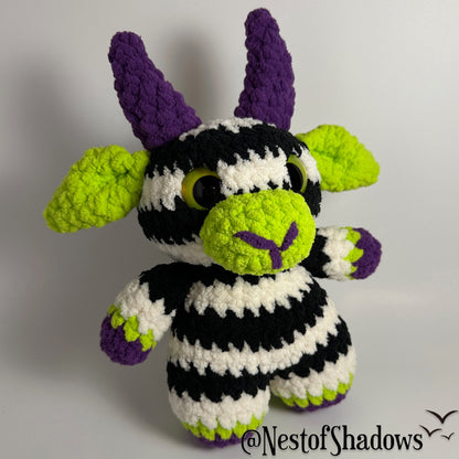 Crochet goat with stripes and white background. Nest of Shadows watermark.