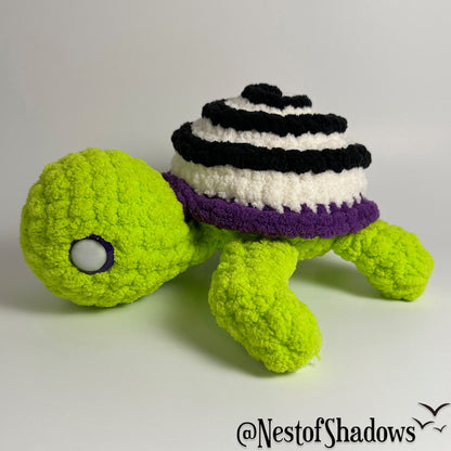 Crochet turtle on a white background. Nest of Shadows watermark.