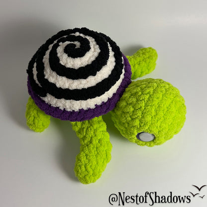 Crochet turtle on a white background. Nest of Shadows watermark.