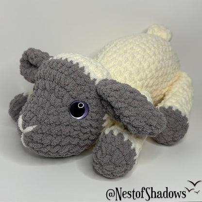Gray and white crochet lab plushie with a white background and Nest of Shadows watermark.