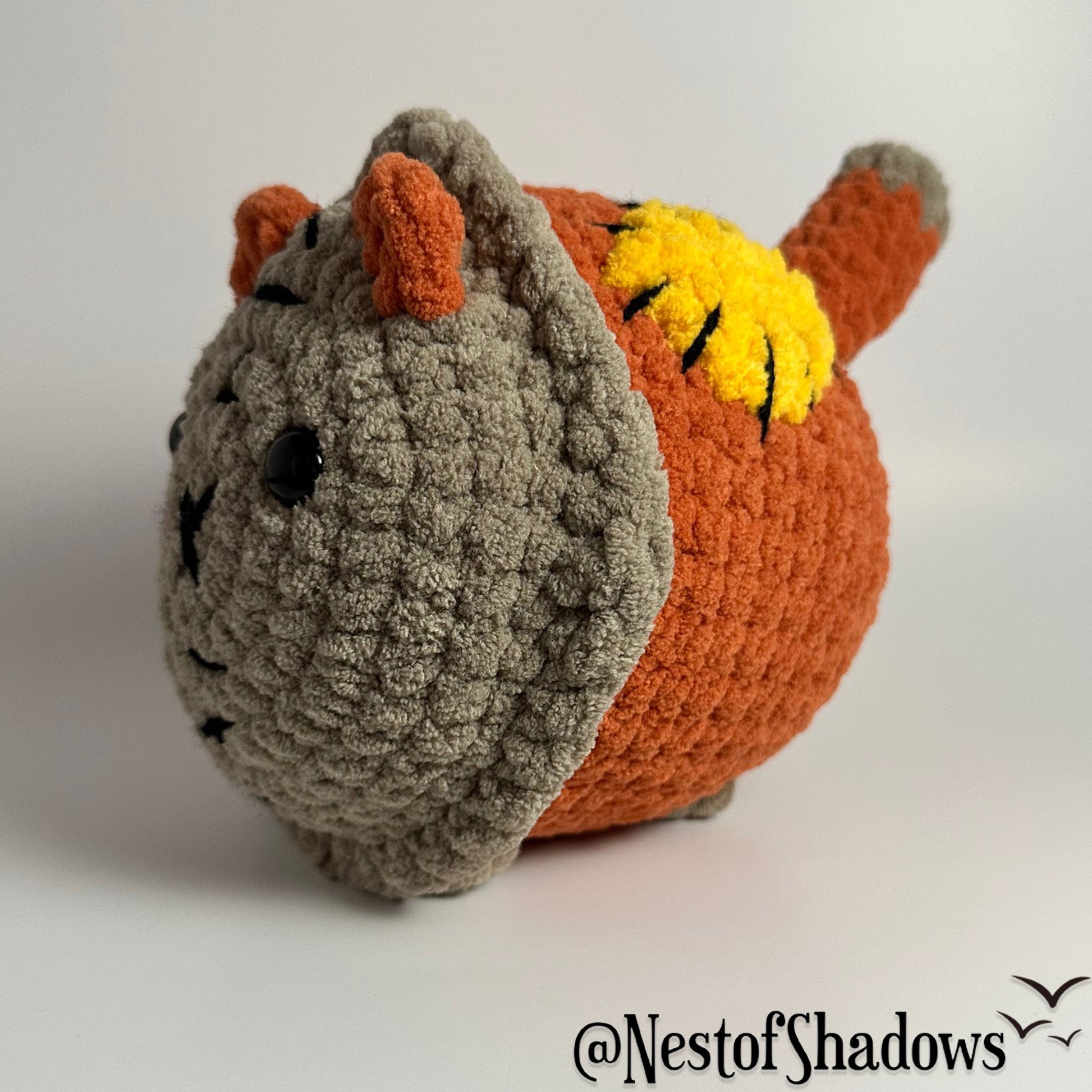 Crochet Cat on a white background. Nest of Shadows watermark.