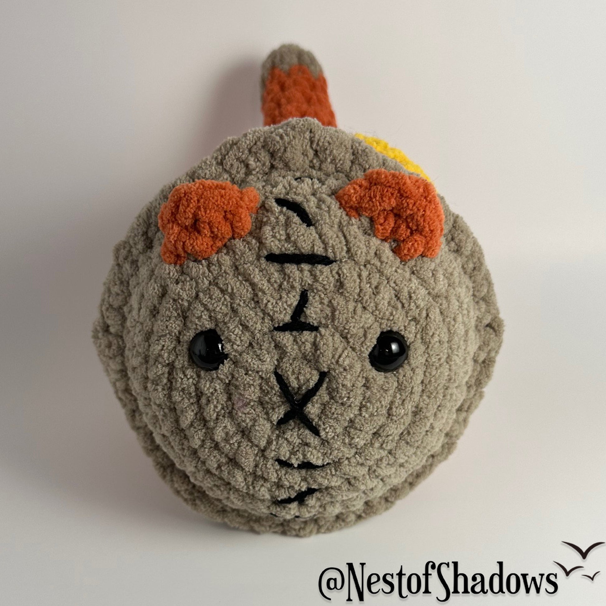 Crochet Cat on a white background. Nest of Shadows watermark.