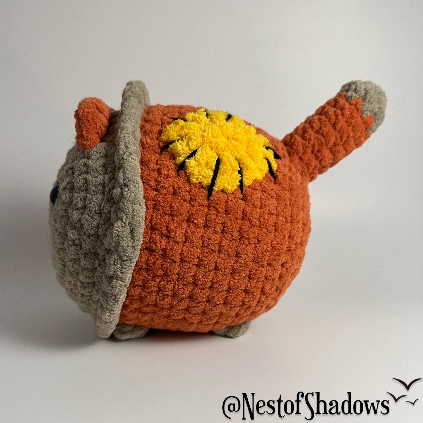 Crochet Cat on a white background. Nest of Shadows watermark.